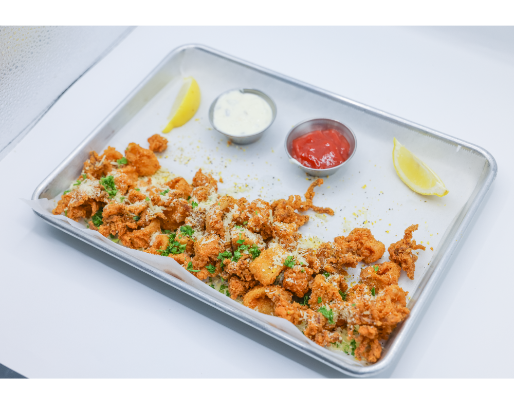 calamari served with lemon ranch and cocktail sauce sprinkled with cheese and cilantro